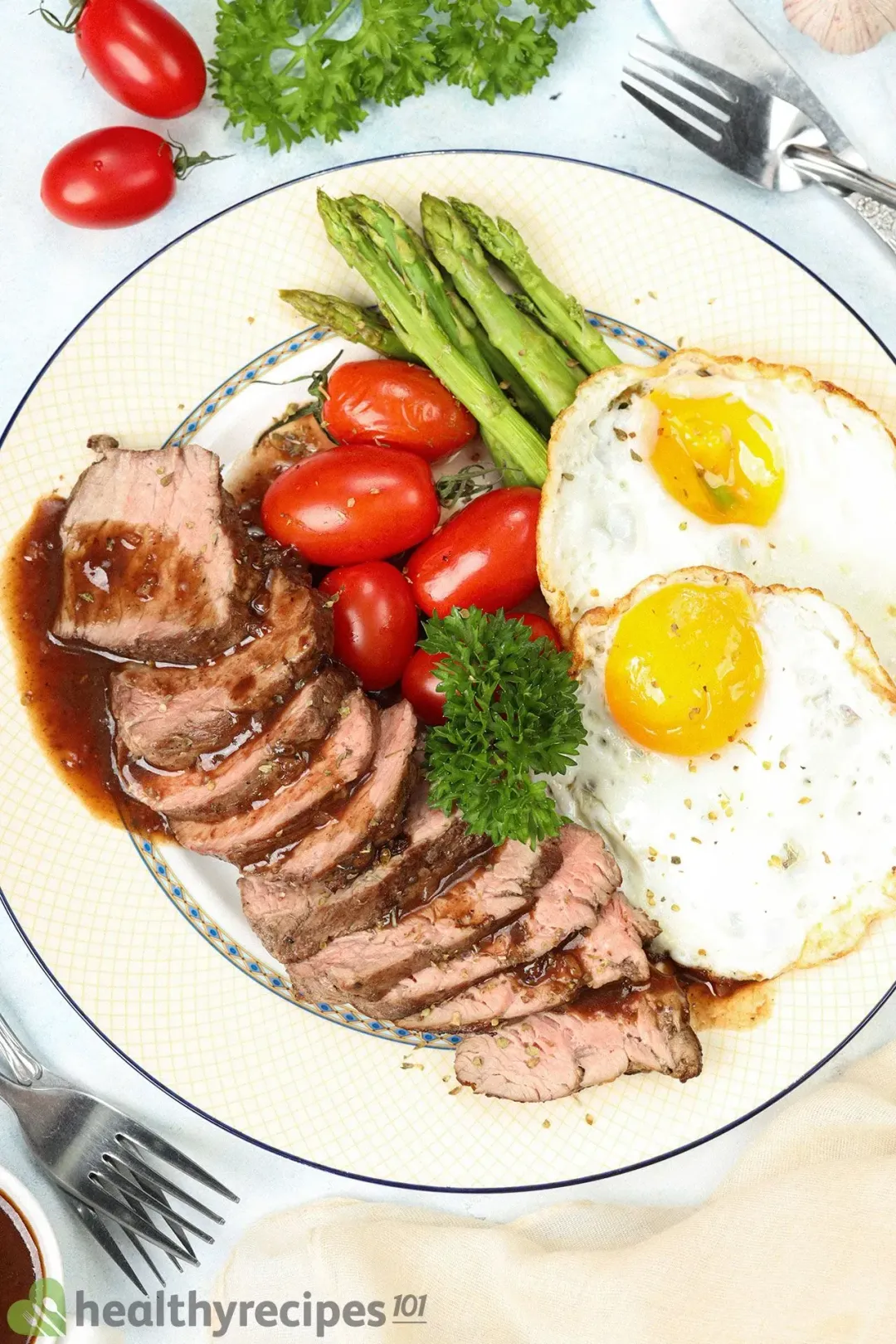 A plate with steak, eggs and tomatoes for an easy protein packed breakfast.