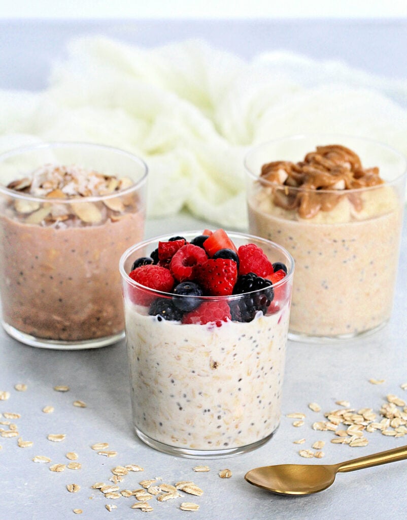 High-Protein Breakfast with Three Bowls of Oats, Berries, and Nuts.