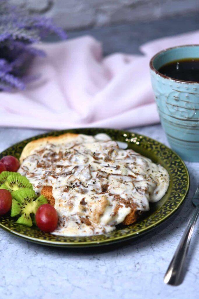 A protein-rich plate of food with venison gray and a cup of coffee for breakfast.