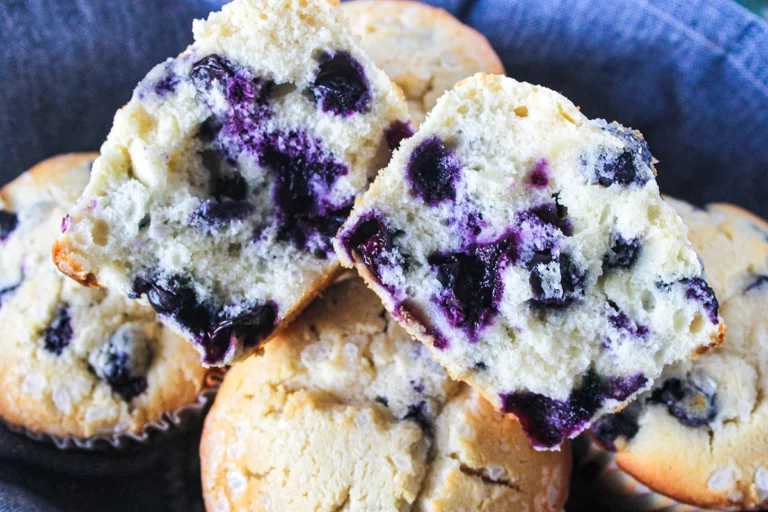 Blueberry muffins in a small batch blue bowl.